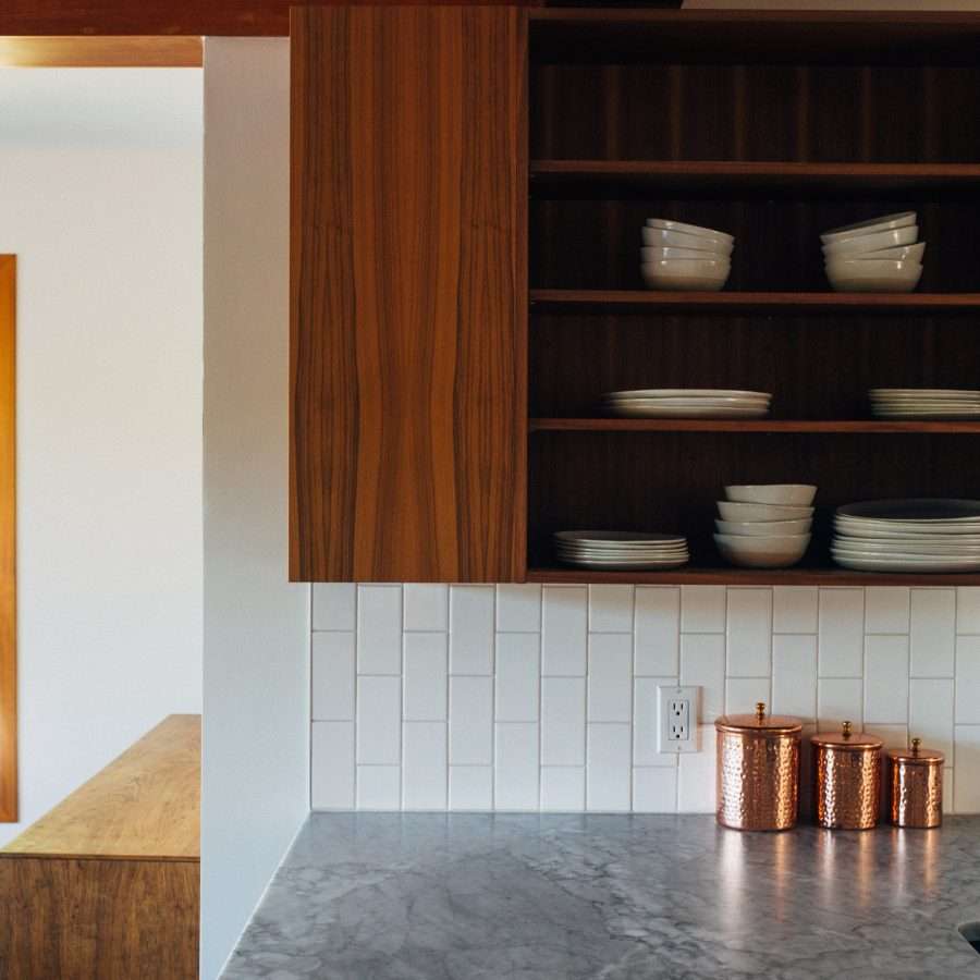  a white kitchen interior with granite worktop