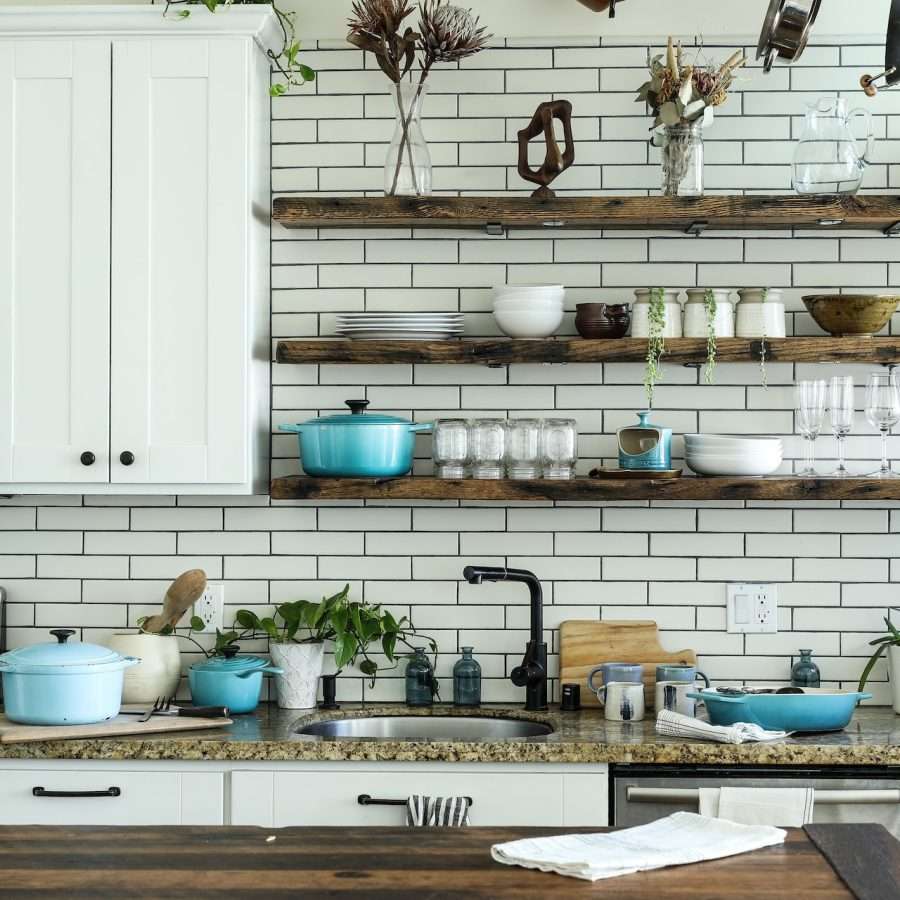 kitchen wall with wooden shelves and white metro tiles