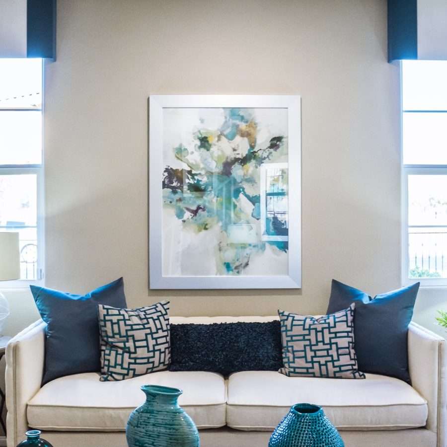 a white sofa near a painting
