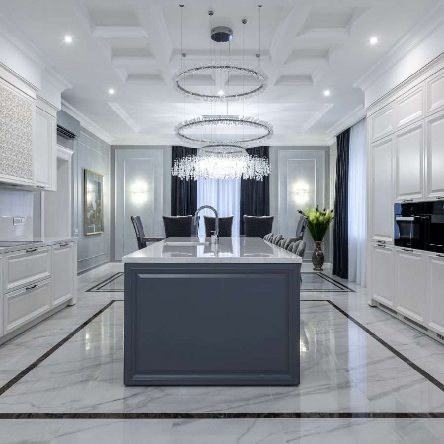  a spacious kitchen with light furniture and white tiles