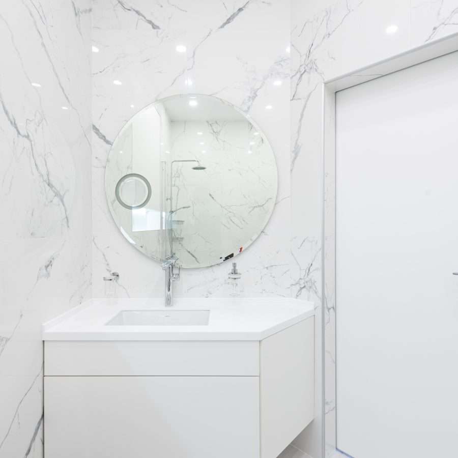  Washroom interior with cabinet with sink and mirror near the door