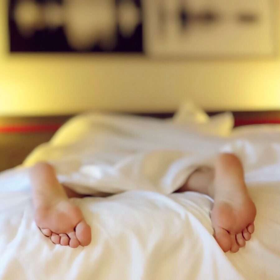 Person Lying on Bed Covering White Blanket