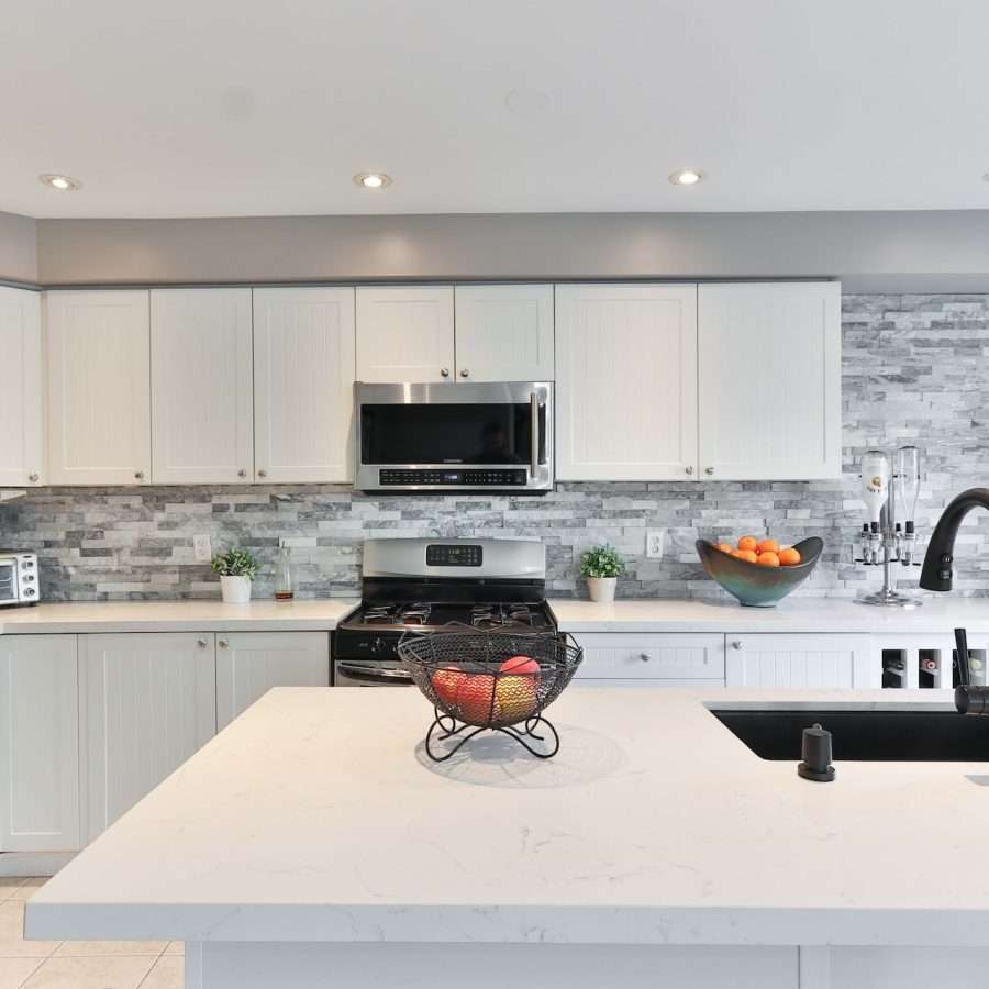  a kitchen interior with black and grey metro tile backsplash