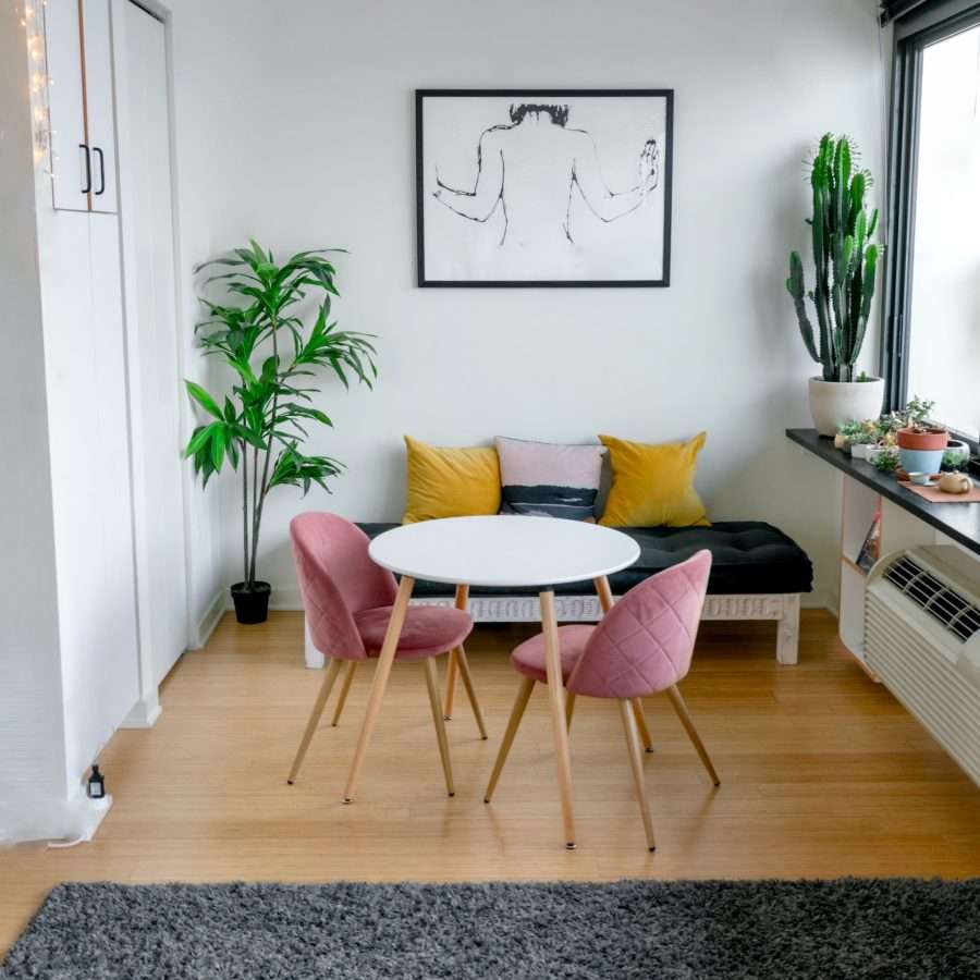 white and pink round table beside white wall